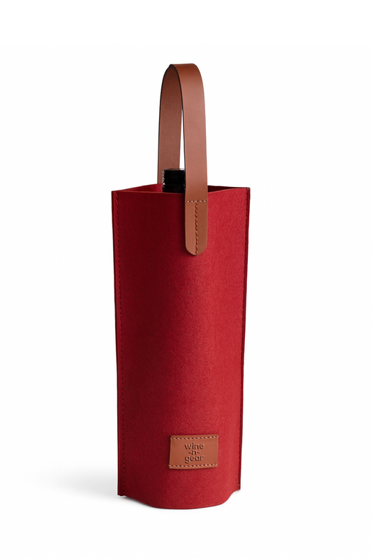 Red wine bottle holder with brown leather handle on a white background